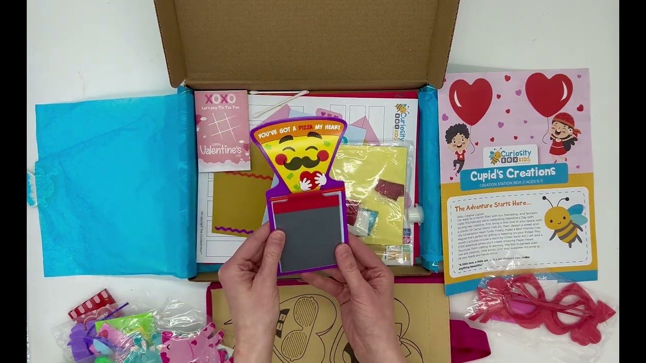 Open Valentine craft box with activities inside